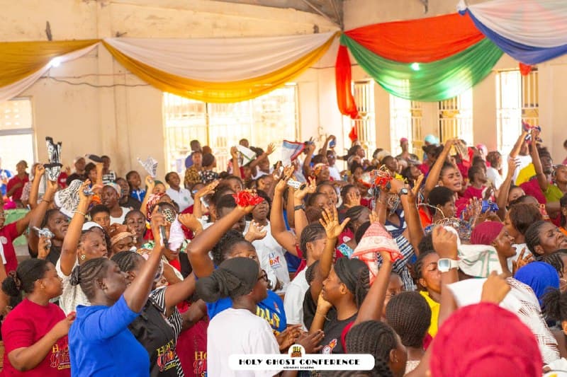 The congregation gathered with hands raised in worship